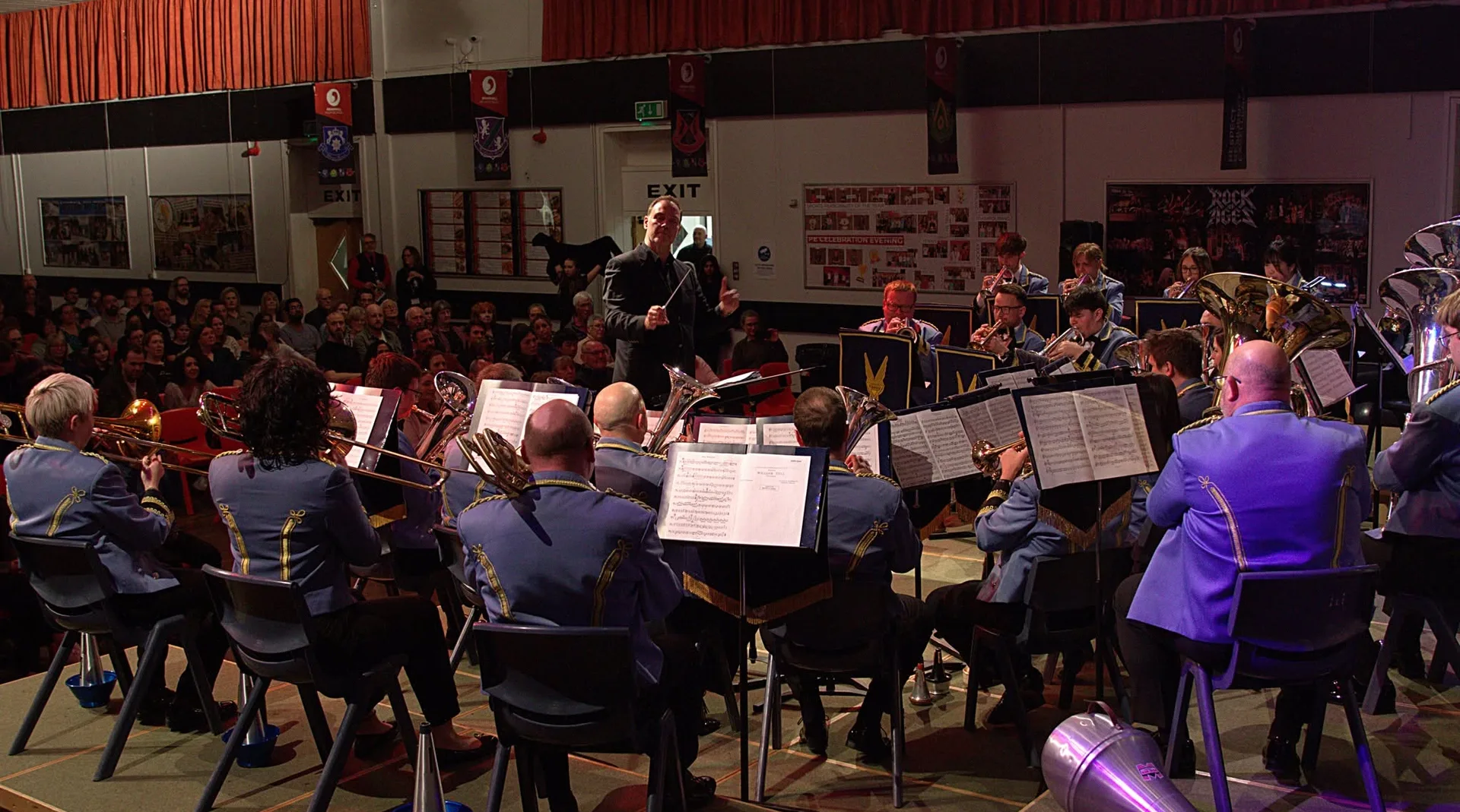 The KNDS Fairey Band performing in concert, conducted in front of a full audience